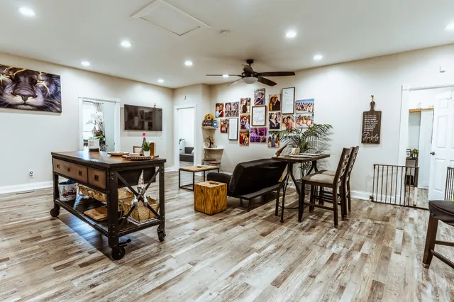 a white house with a big yard and large trees