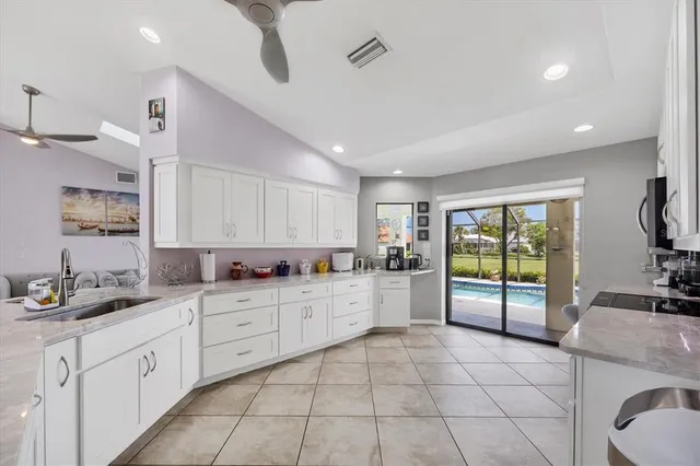 a large kitchen with a large window appliances and cabinets