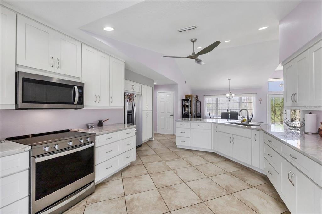 4 Leeward Drive Placida, FL 33946 - Photo 14 of 37 a kitchen with stainless steel appliances a stove microwave and cabinets