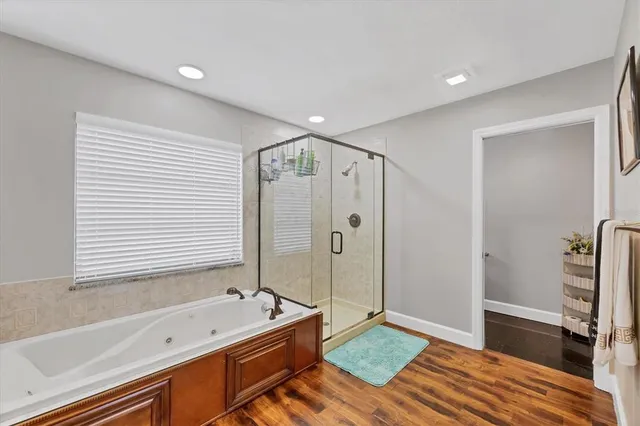 a bathroom with a tub a sink and a shower