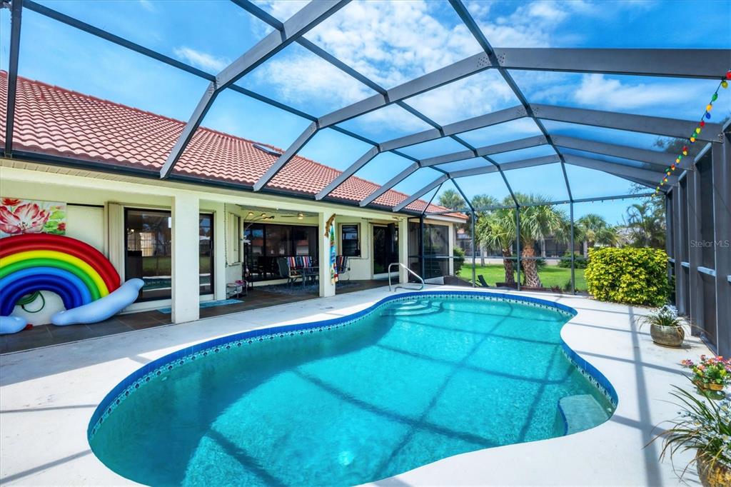 4 Leeward Drive Placida, FL 33946 - Photo 28 of 37 a view of a patio with table and chairs potted plants with floor to ceiling window and potted plants