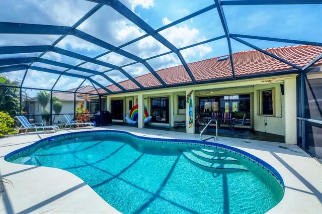 a view of a patio with table and chairs under an umbrella