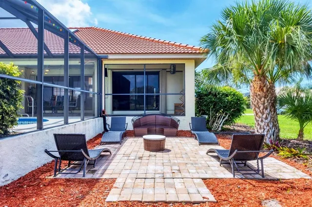 a view of a patio with couple of chairs and a table