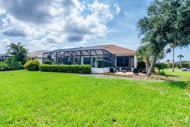 a front view of a house with swimming pool and green space