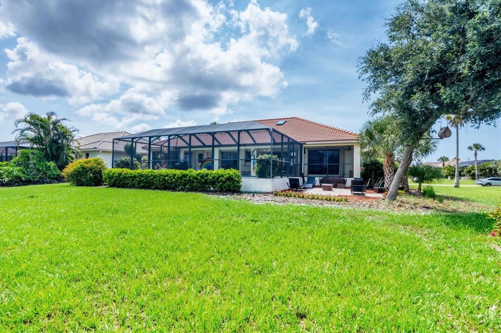 4 Leeward Drive Placida, FL 33946 - Photo 31 of 37 a front view of a house with swimming pool and green space