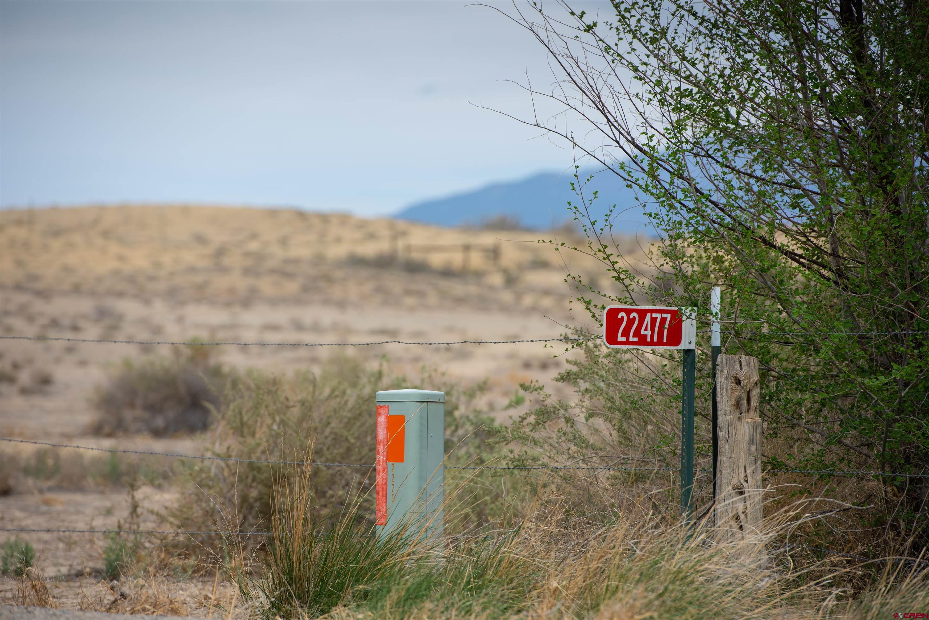 22477 F Road Delta, CO 81416 - Photo 11 of 35 a view of sign board with buildings and trees