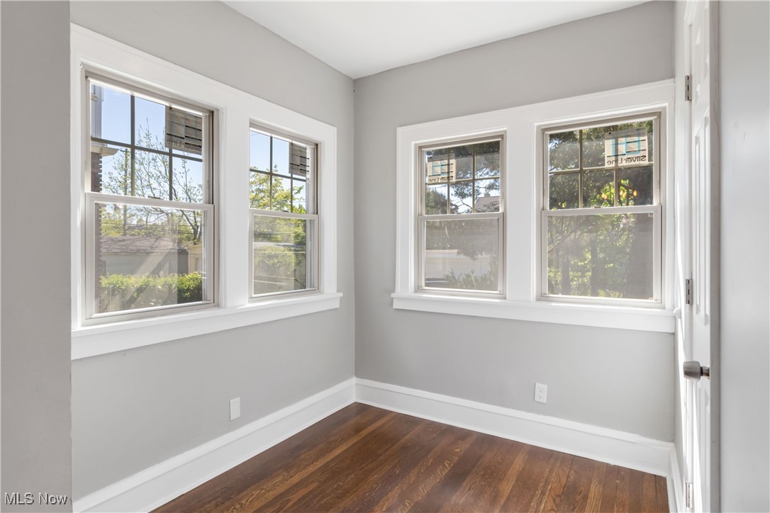 3566 Ludgate Road Cleveland, OH 44120 - Photo 13 of 27 Spare room with baseboards and dark wood-type flooring