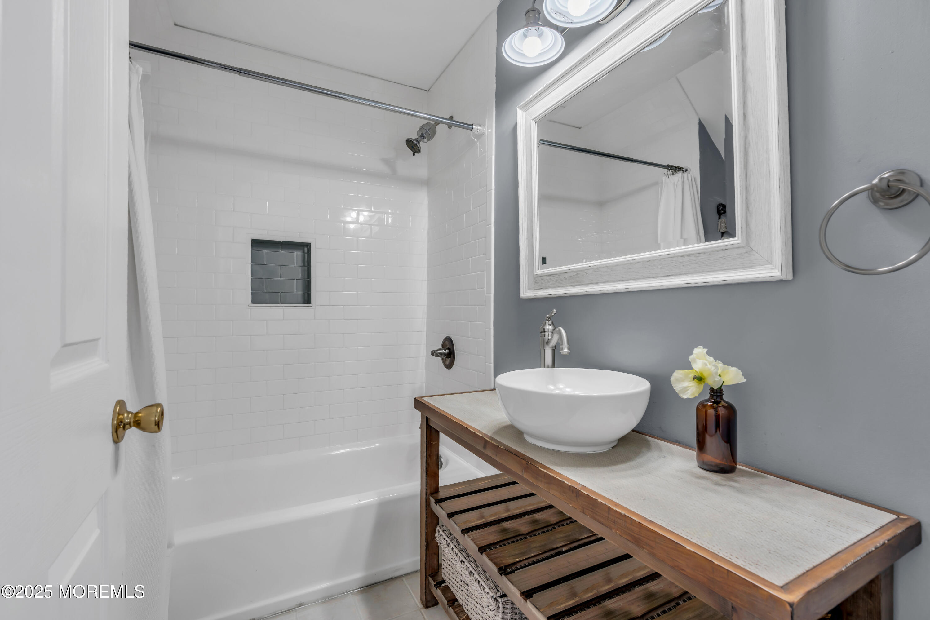 2228 Wilson Road Point Pleasant, NJ 08742 - Photo 46 of 65 a bathroom with a sink bath tub and a mirror