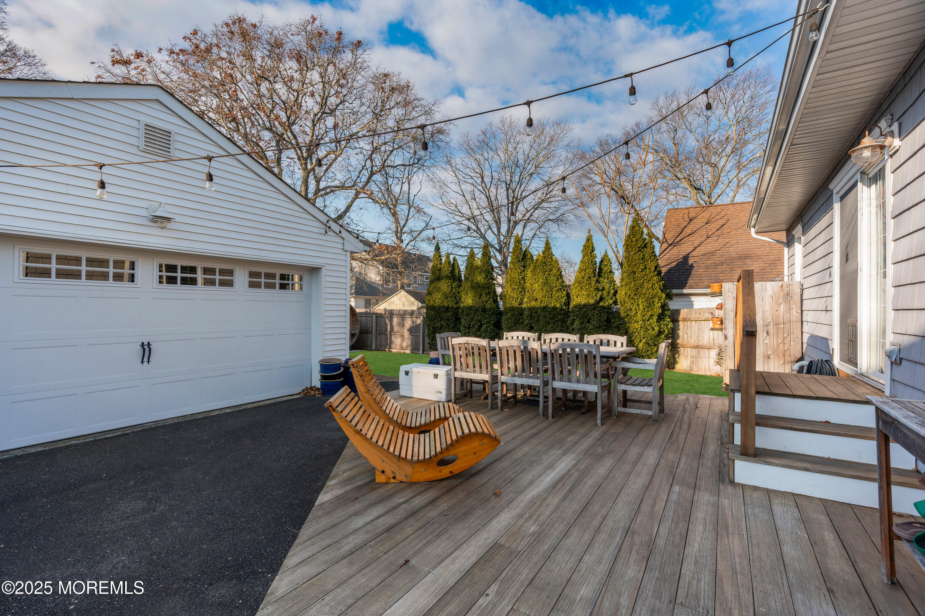 2228 Wilson Road Point Pleasant, NJ 08742 - Photo 54 of 65 a view of a patio with table and chairs with wooden floor and fence