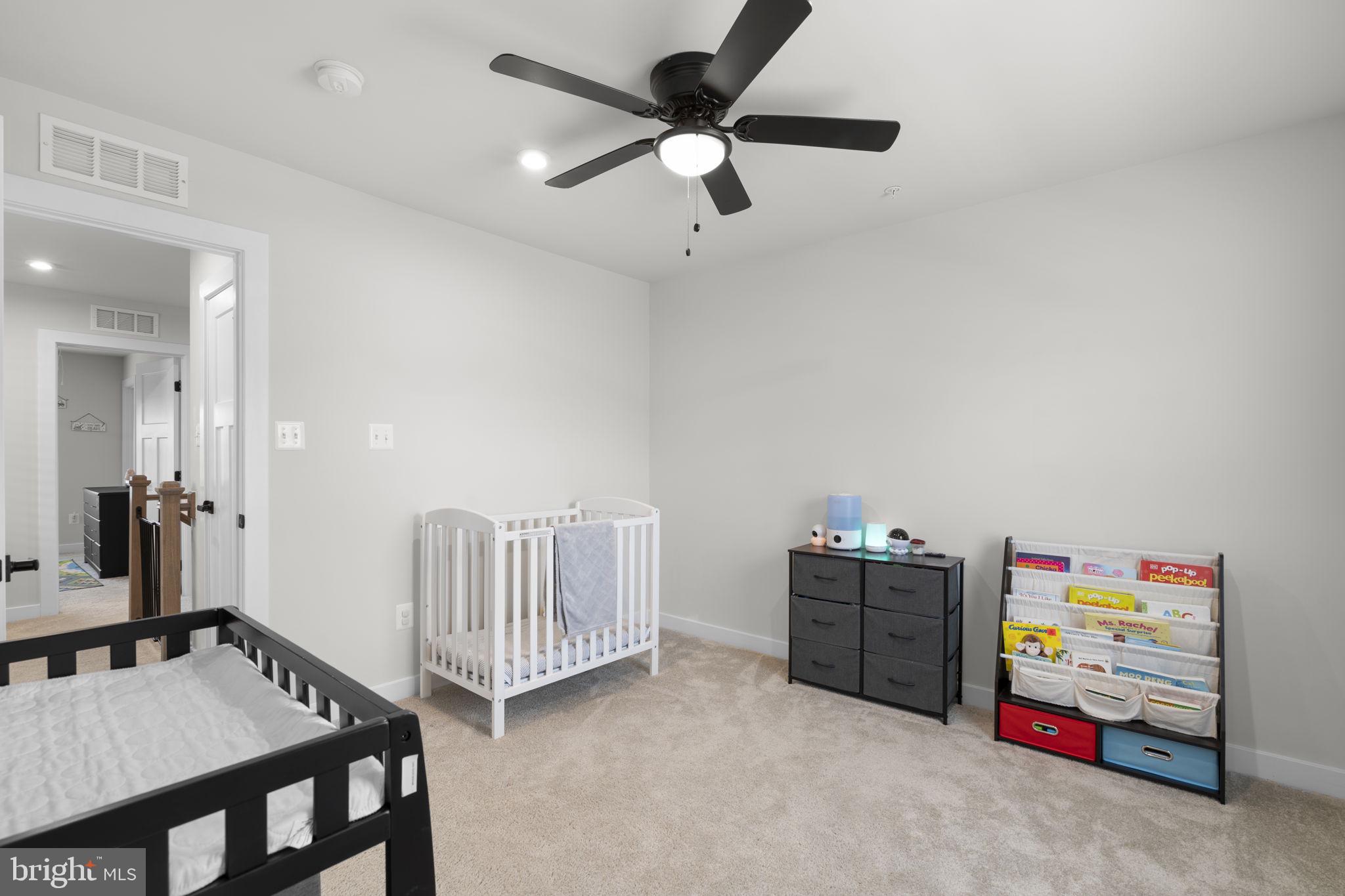 1713 Aurora Way Frederick, MD 21702 - Photo 38 of 57 a living room with furniture and a baby crib