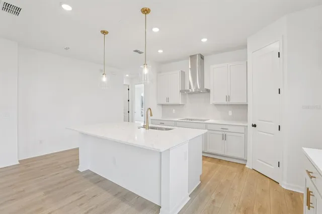 a kitchen with a sink stainless steel appliances and cabinets