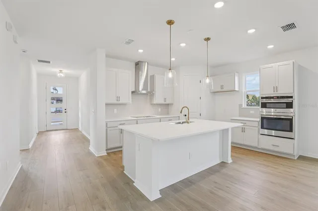 a kitchen with white cabinets and a stove