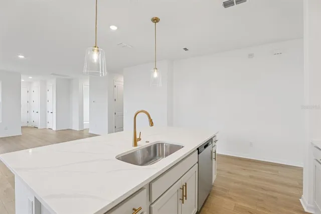 a close view of a sink a faucet and appliance in the kitchen