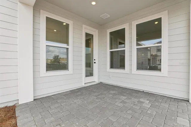 a white vase with white flowers