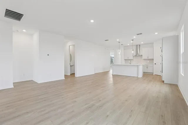 a large kitchen with kitchen island a sink stainless steel appliances and cabinets