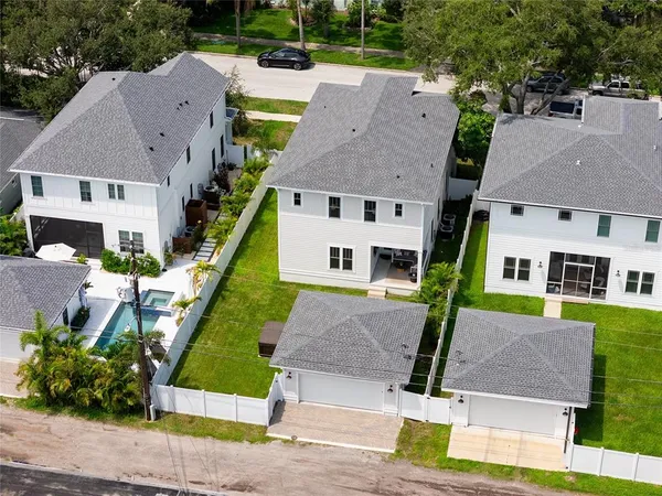 an aerial view of a house with a yard