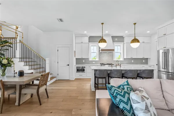 a large kitchen with a table and chairs