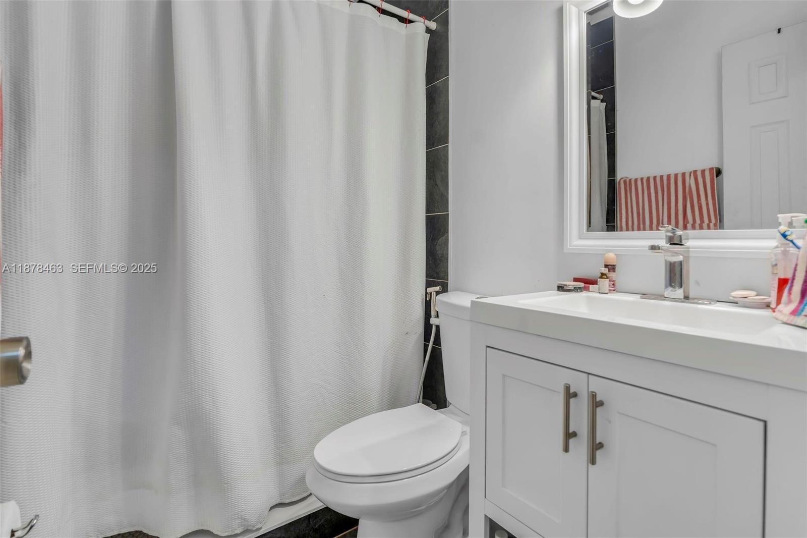 580 Southeast 2nd Street Hialeah, FL 33010 - Photo 11 of 30 a bathroom with a sink toilet and a mirror