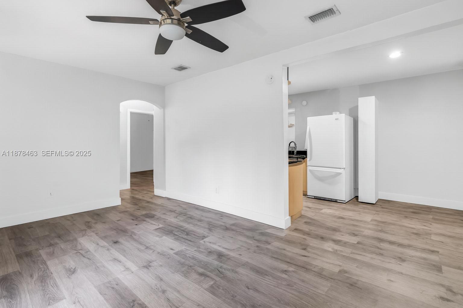 580 Southeast 2nd Street Hialeah, FL 33010 - Photo 3 of 30 a view of empty room with wooden floor and ceiling fan