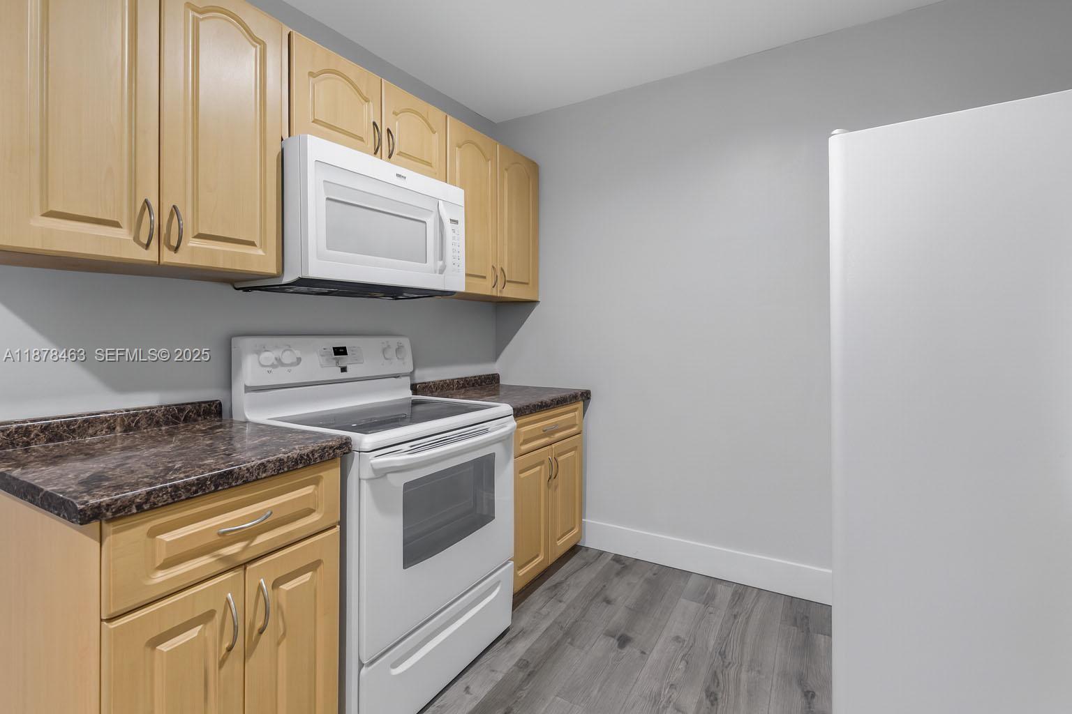 580 Southeast 2nd Street Hialeah, FL 33010 - Photo 7 of 30 a stove top oven sitting inside of a kitchen