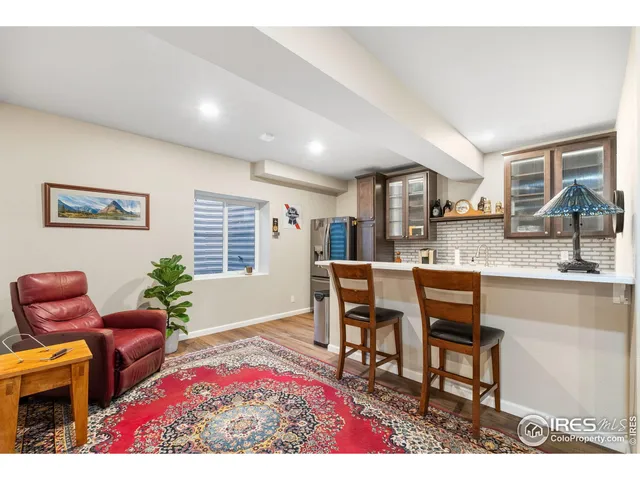 a view of kitchen with granite countertop cabinets and window