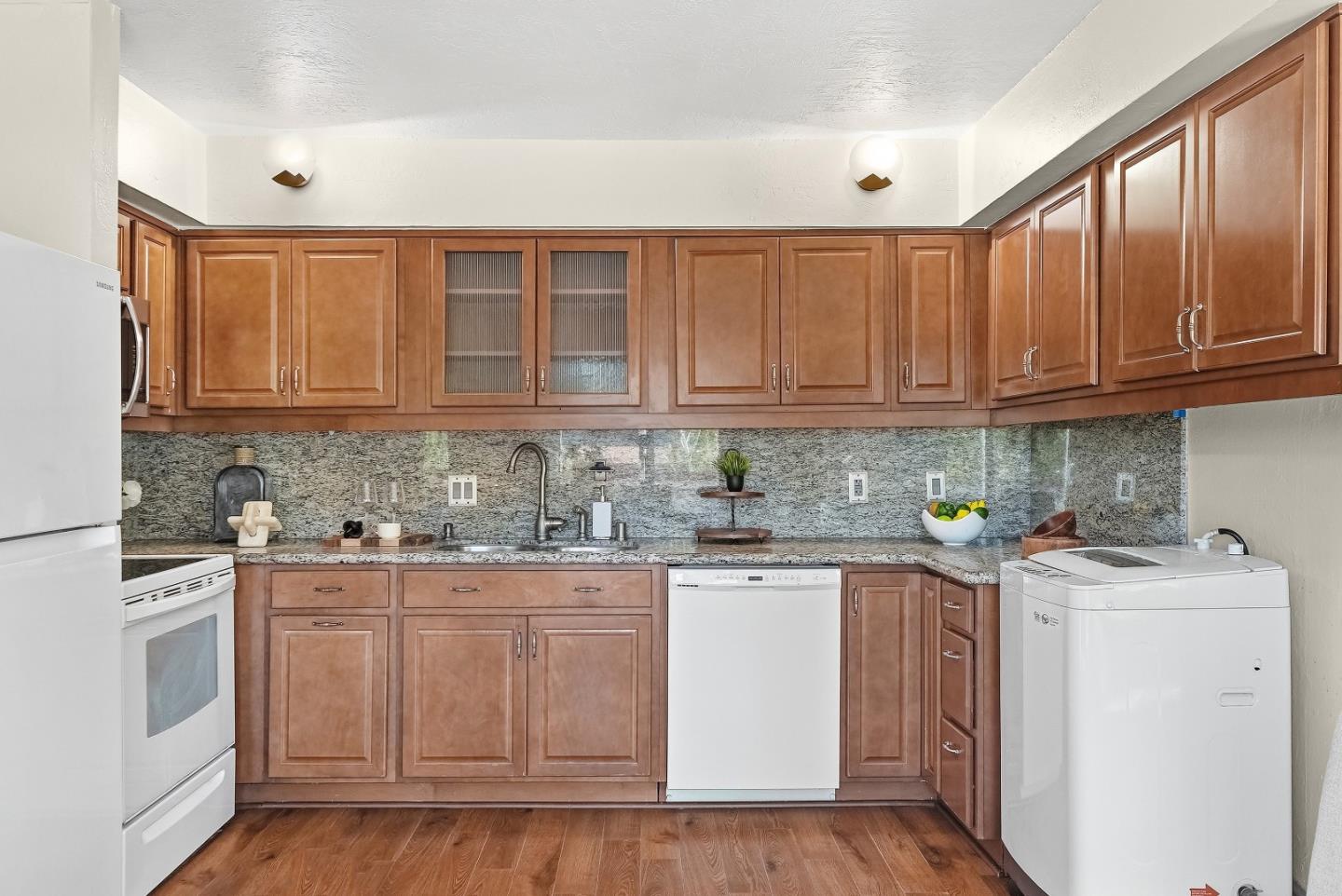 701 North Rengstorff Avenue, Unit 7 Mountain View, CA 94043 - Photo 9 of 32 a kitchen with stainless steel appliances granite countertop a sink and cabinets with wooden floors