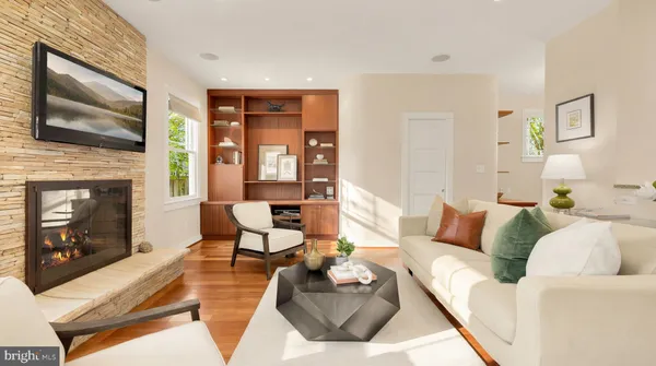 a living room with furniture fireplace and flat screen tv