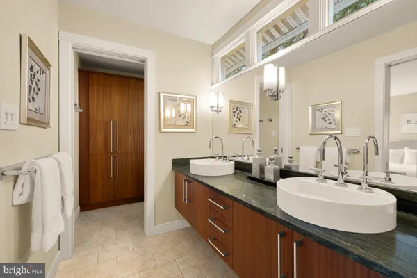 a bathroom with double sink and a mirror