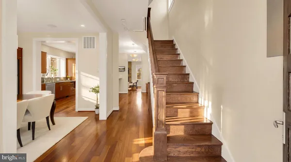 a view of a living room with wooden floor and chairs