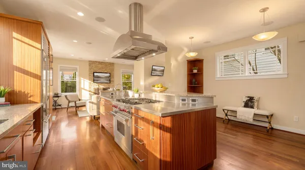 a large kitchen with lots of counter space and painting on the wall