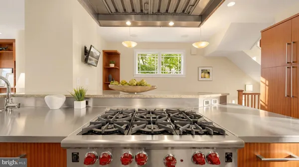 a kitchen with stainless steel appliances kitchen island granite countertop a stove a sink and a microwave
