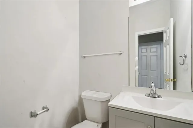 a bathroom with a sink toilet and a mirror