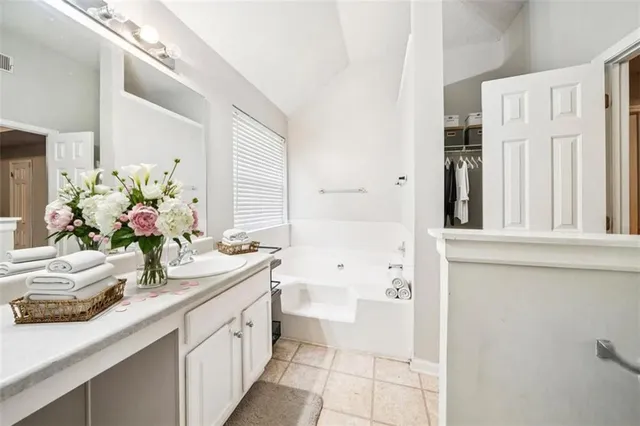 a bathroom with a sink a vanity and a mirror