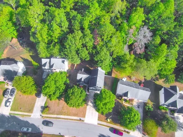 an aerial view of a house with a yard and garden space