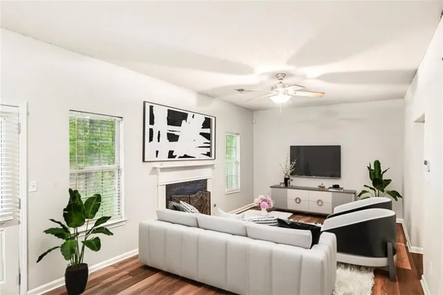 a living room with furniture a fireplace and a potted plant