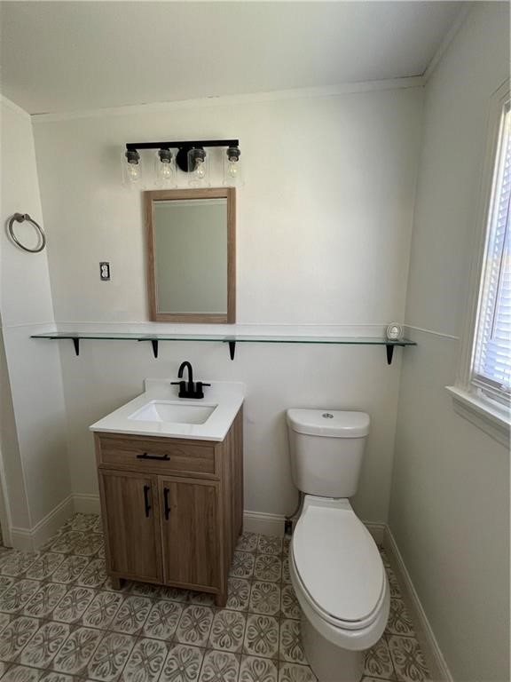 3662 Austin Street Corpus Christi, TX 78411 - Photo 9 of 22 a bathroom with a toilet a sink and mirror