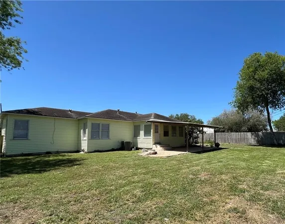 a view of an empty room with closet and a window