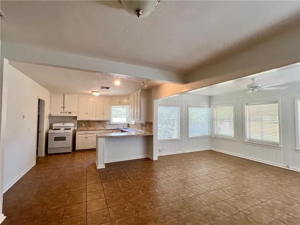 a view of an empty room with windows
