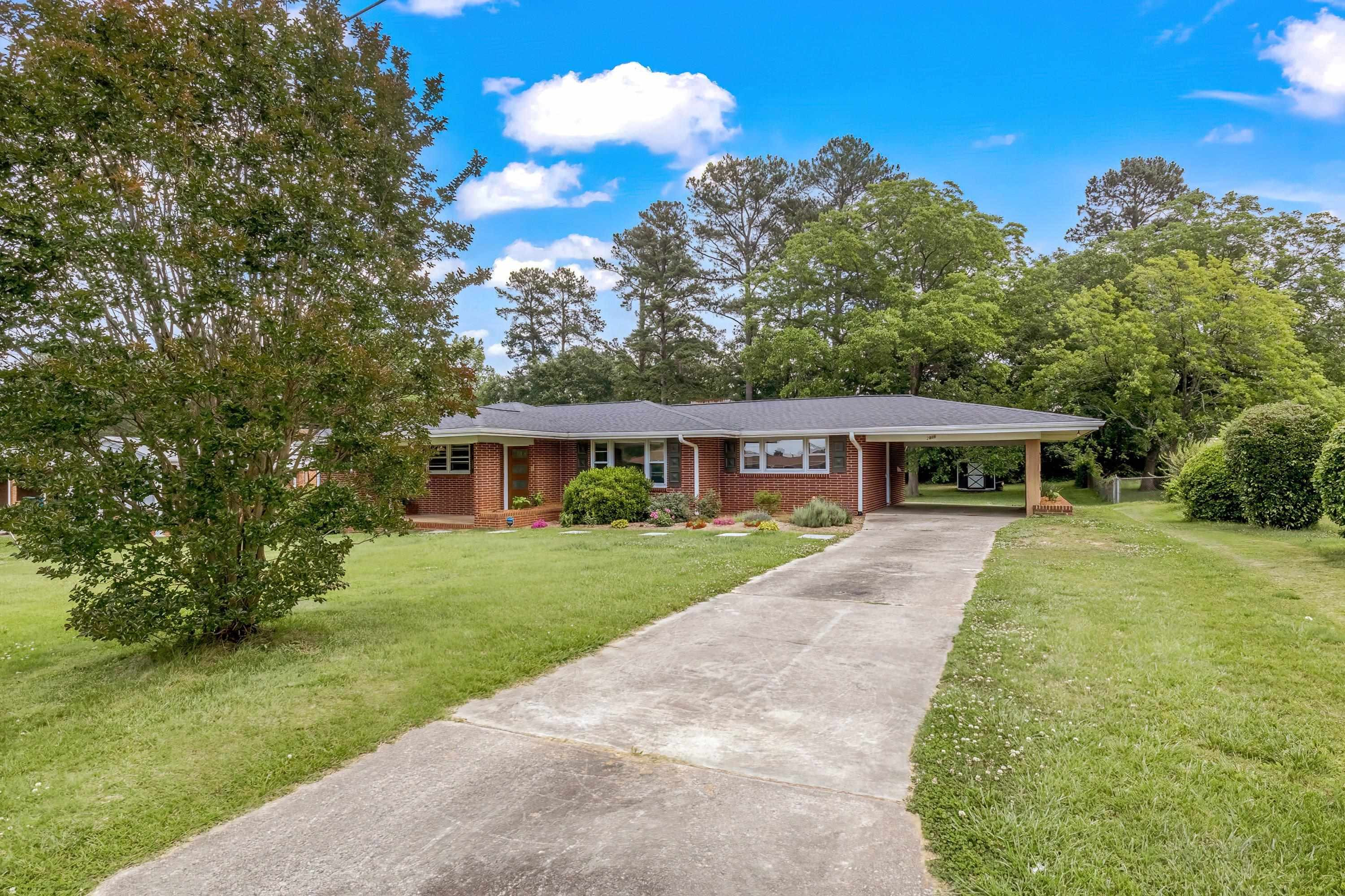 2405 Brenda Drive Raleigh, NC 27610 - Photo 3 of 27 a view of a big yard with plants and large trees