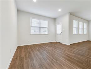 968 Rice Drive Bryan, TX 77803 - Photo 6 of 12 an empty room with wooden floor and windows