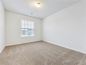 968 Rice Drive Bryan, TX 77803 - Photo 9 of 12 an empty room with windows