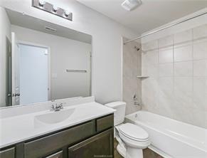 968 Rice Drive Bryan, TX 77803 - Photo 10 of 12 a bathroom with a sink a toilet and a mirror