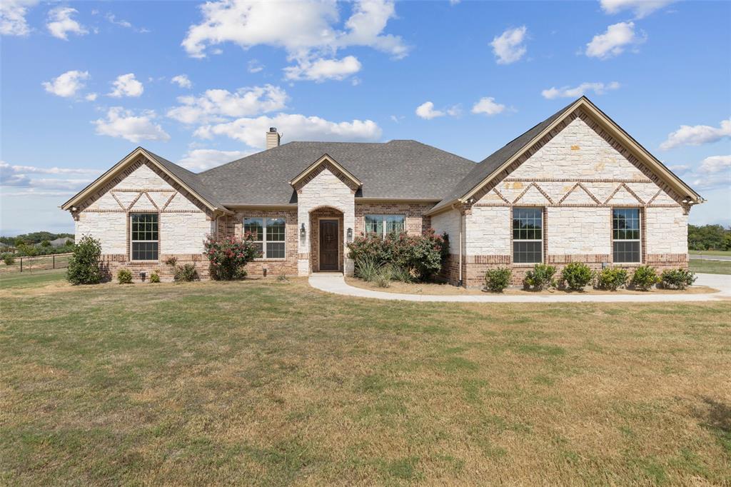 a view of a house with a yard and garage