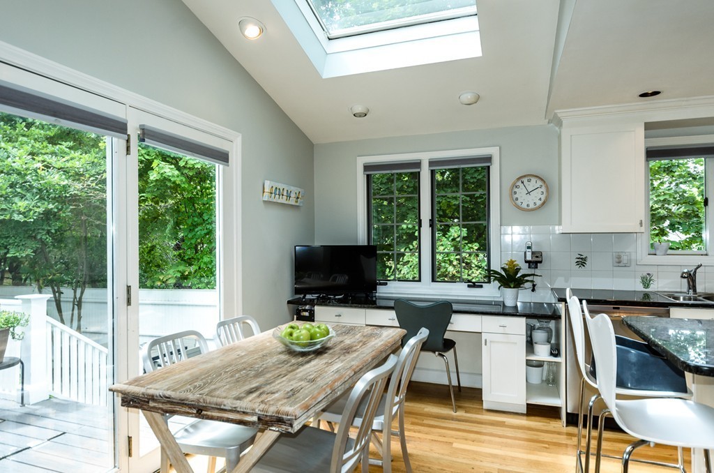 27 Coolidge Road Newton, MA 02459 - Photo 8 of 24 a kitchen with a table chairs and wooden floor