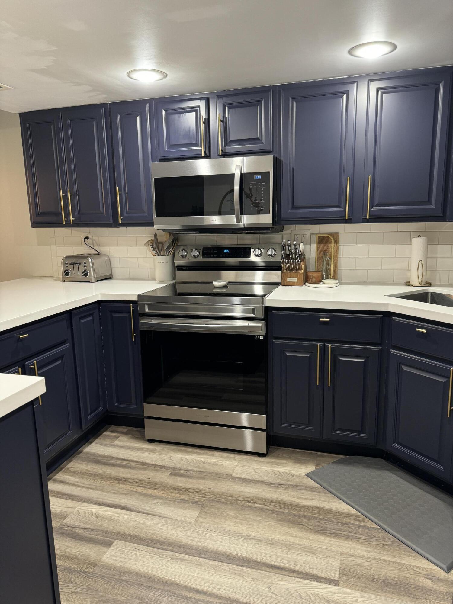 4601 Northwest 2nd Avenue, Unit 805 Boca Raton, FL 33431 - Photo 9 of 34 blue cabinets gold hardware