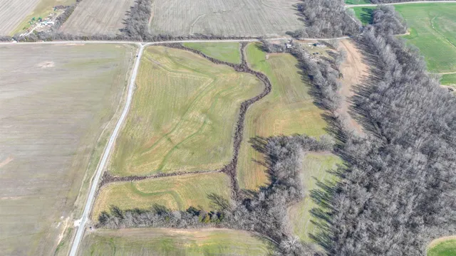 a view of a lake and a field