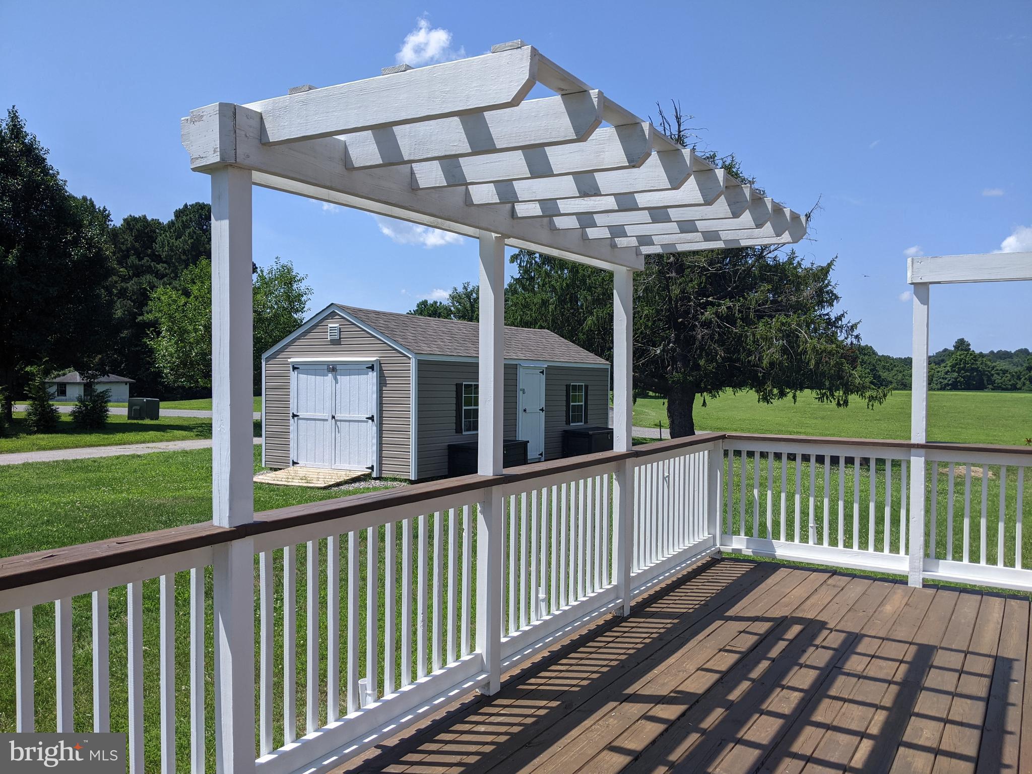 6825 Briscoe Turn Road Owings, MD 20736 - Photo 47 of 47 a view of a wooden deck and a yard with swimming pool