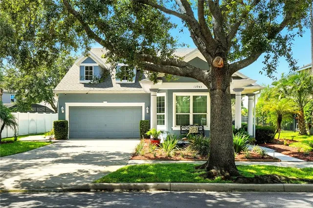 a front view of a house with a yard and potted plants
