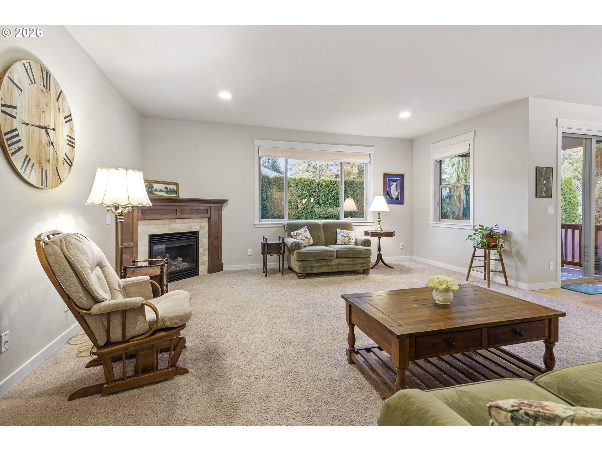 3110 Northeast 174th Street Ridgefield, WA 98642 - Photo 15 of 36 a living room with furniture a fireplace and a table