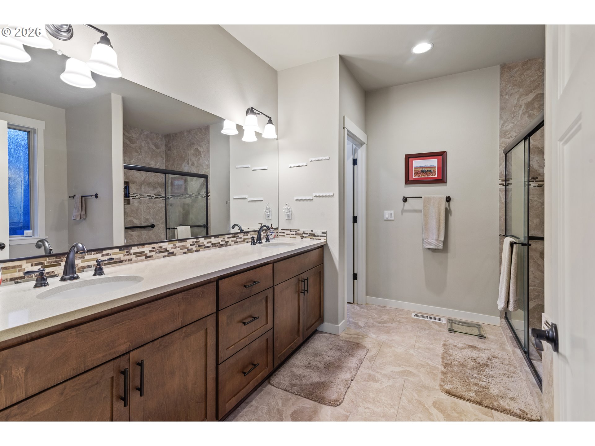 3110 Northeast 174th Street Ridgefield, WA 98642 - Photo 23 of 36 a bathroom with a double vanity sink a mirror and a shower
